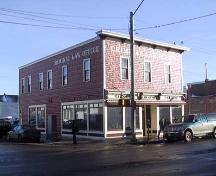 This image illustrates the overall form and massing of the Kingston Powell Building, in its corner location as seen from the northwest (2004).; City of Edmonton, 2004