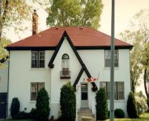 View of the main entrance to the VIP Private Married Quarters, showing the simple lines, the white-painted stucco surfaces, and the painted wood sash windows with metal railings and doors, 2004.; Parks Canada Agency / Agence Parcs Canada, 2004.