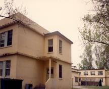 View of Building S-136, showing the wrap-around continuity of the projecting belt courses, 1992.; Department of National Defence / Ministère de la Défense nationale, 1992.