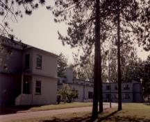 Rear view of Building O-109 (NCO Building), showing the building's modern style, 1992.; Department of National Defence / Ministère de la Défense nationale, 1992.