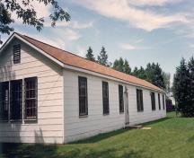 Side view of Building E-108, showing its numerous windows and its basic functional cladding.; Department of National Defence / Ministère de la Défense nationale.
