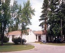 General view of Building E-108, showing its one-storey massing and gable roof.; Department of National Defence / Ministère de la Défense nationale.
