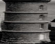 General view of the Lighthouse, showing the Gothic-arched casement windows and the rounded entranceway, circa 1975.; Transport Canada / Transports Canada, circa/vers 1975.