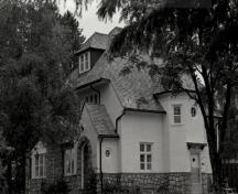 General view of the Superintendent's Residence, showing the complex roofline and the gable roof with projecting eaves, 1989.; George A. Armstrong, 1989.