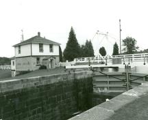 Vue d'ensemble de la résidence fortifiée du maître-éclusier de Lower Brewers, qui montre son échelle générale, son style et les matériaux employés, qui s’harmonisent avec les abords du poste d’éclusage, 1989.; Department of Public Works / Ministère des Travaux, 1989.