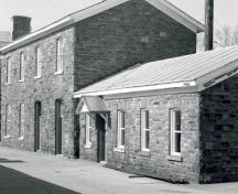View of the exterior of the Workshop, showing the exterior walls of random coursed red sandstone, 1985.; Parks Canada Agency / Agence Parcs Canada, 1985.