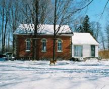 General view of Former Atha School House, showing the clean, simple lines and massing composed of a one-storey, rectangular brick block capped with a broad gable roof, 2005.; Department of Public Works and Government Services / Ministère des Travaux publics et services gouvernementaux, Alice Da Silva, 2005.