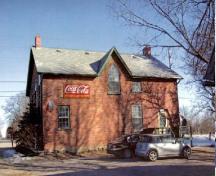 General view of the Former Commercial Hotel, showing the gable roof, dormers and chimneys, 2005.; Public Works and Government Services Canada / Travaux publics et services gouvernementaux Canada, 2005.