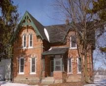 View of the main entrance of Former Miller Residence, showing the well-proportioned composition of its main façade, which features narrow windows, a single roof dormer, and a main entry porch, 2005.; Department of Public Works and Government Services / Ministère des Travaux publics et services gouvernementaux, 2005.