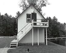 Side view of the Storehouse, Lock Office, showing the exterior wooden staircase, 1989.; Public Works and Government Services Canada / Travaux publics et Services gouvernementaux Canada, 1989.