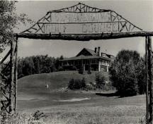 View of the Golf Clubhouse (B7), showing its site on the ridge of a promontory adjacent to the golf course.; Agence Parcs Canada / Parks Canada Agency