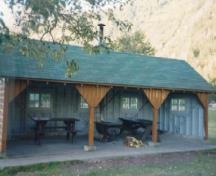 General view of Kitchen Shelter 11, showing the central metal cookstove with a masonry chimney, 1990.; Parks Canada Agency / Agence Parcs Canada, 1990.