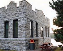 Corner view of RMC Building 24, showing the regular fenestration, including large, vertical windows.; Parks Canada Agency / Agence Parcs Canada.
