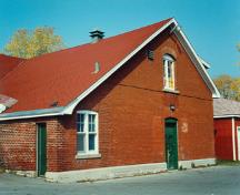 View of RMC Building 36 from an angle, showing the gable-roofed skyline, 1993.; Parks Canada Agency / Agence Parcs Canada, 1993.