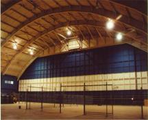 The interior of the hangar space of Hangar 11, showing the west interior elevation with the aircraft doors that are lower than the other elevations with aircraft doors,  2001.; Agence Parcs Canada / Parks Canada Agency, E. Tumak, 2001.