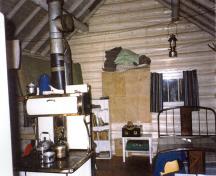 Front view of the Jacques Lake Warden Cabin, showing the brown stain finish of the logs and the whitewashed log ends, 1996.; Parks Canada Agency / Agence Parcs Canada, 1996.