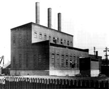 General view of the Ottawa Electric Railway Company Steam Plant from the northwest, showing the stepped massing, which is composed of a one-storey and two-storey block with a small addition to the west, 1958.; COA, OER Collection, CA-15021, 1958.