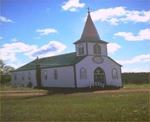 General view of the Church of Our Lady of Good Hope showing the steeple above front entry; with pointed arch, louvered windows on three faces, 1980.; Parks Canada / Parcs Canada, 1980