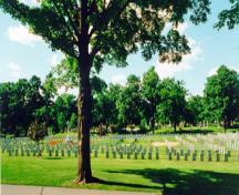 General view of the military section of the Beechwood Cemetery showing the Cross of Sacrifice erected by The Commonwealth War Graves Commission and its central placement within the military cemetery, 2000.; Parks Canada Agency / Agence Parcs Canada, R. Godspeed, 2000.