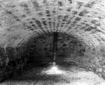Interior view of the North Front Casemate emphasizing the bomb-proof elliptical masonry vault of each unit, 1989.; Parks Canada Agency / Agence Parcs Canada, 1989.