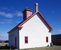 Corner view of the rear of the Sick Horse Stable, showing the gable roof and gable roofed lantern, 2003.; Parks Canada Agency / Agence Parcs Canada, M. Fieguth, 2003.
