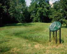 General view of Southwold Earthworks National Historic Site of Canada, showing the earthworks, which form a double ring of low earthen mounds that surround the site.; Parks Canada Agency / Agence Parcs Canada.