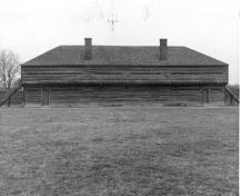 Vue de la façade, qui montre les murs extérieurs construits de rondins équarris assemblés à queue d’aronde, vers 1989.; Parks Canada Agency / Agence Parcs Canada, circa 1989.