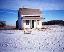 General view of the former Jean Caron Sr. House showing the main, three-bay façade with a central door and two flanking windows, 2002.; Parks Canada Agency / Agence Parcs Canada, I. Wilson, 2002.