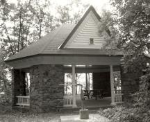 View of the main entrance to the West Grenadier Island Pavilion, showing the slender, wooden columns at front and rear entry points, 1992.; Parks Canada Agency / Agence Parcs Canada, 1992.