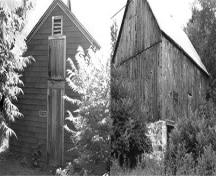 Exterior view of the Massey Farmstead, showing the calving barn on the left and the large barn on the right, 1992.; Parks Canada Agency / Agence Parcs Canada, Historica Resources Ltd., 1992.