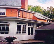 General view at the rear of the Residence, showing the slate roof, copper downspouts and exterior ornamental woodwork, 1999; Parks Canada Agency / Agence Parcs Canada, Leslie Maitland, 1999.