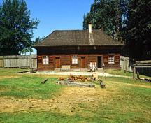 General view of the main entrance to the Servants' Quarters showing Its formally arranged windows and elevated entry doors, 2002.; Parks Canada Agency / Agence Parcs Canada, M. Trepanier, 2002.