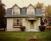 Front facade of the Superintendent's Residence showing its two-storey structure with a bell-cast gambrel roof and two bell-cast dormers.; Parks Canada Agency / Agence Parcs Canada, n.d.