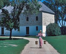 General view of the Warehouse showing the rubble masonry with corner quoins and plain stone lintels and sills, 1989.; Parks Canada Agency / Agence Parcs Canada, W. Lynch, 1989.