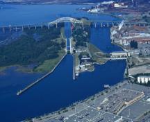 Aerial view of Sault Ste. Marie Canal showing the engineering works, buildings and designed landscape features.; Parks Canada Agency / Agence Parcs Canada.