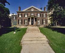 General view of The Grange showing its siting at the end of a green and treed park.; Parks Canada Agency / Agence Parcs Canada.