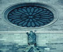 Detail view of St. Patrick's Basilica, showing its French Gothic Revival rose window, 1995.; Parks Canada Agency / Agence Parcs Canada, P. St. Jacques, 1995.