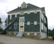 This image illustrates the boys' west side entrance framed by Tuscan pilasters supporting simple cornices. ; PNB 2005