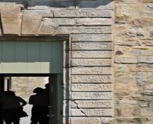 Detail of the Fort Chambly main entrance portal emphasized by rusticated stonework inscribed with the names of notable figures in the history of New France; Agence Parcs Canada | Parks Canada Agency