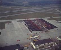 View of 10 Hangar showing its striking design and location along the main runway, 1970.; Department of National Defence / Ministère de la Défense nationale, 1970.