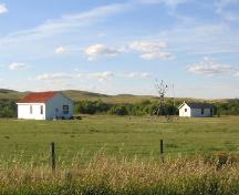 View northwest at park and reconstructed buildings (storehouse on left; barracks on right), 2004.; Government of Saskatchewan, Marvin Thomas, 2004.