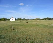 View north at reconstructed barracks with cellar depressions of former buildings in foreground, 2004.; Government of Saskatchewan, Marvin Thomas, 2004.