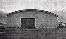General view of Hangar 5, showing its simple, one-storey rectangular massing with a low bowed roof.; Department of National Defence / ministère de la Défense nationale