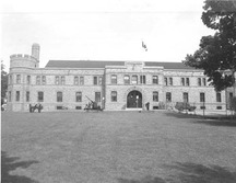 General view of the Armoury, showing the large scale, symmetrical, low massing of the long principal façade, 1989.; Department of National Defence / Ministère de la Défense nationale, 1989.