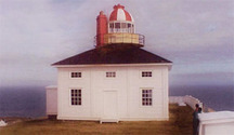 General view of Cape Spear Lighthouse demonstrating the expression of neoclassical design principles in the large balanced rectangular windows on the ground floor topped by smaller ones (some false) on the upper storey, 2000.; Parks Canada | Parcs Canada, 2000