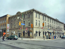 Corner view of the Former Geological Survey of Canada Building showing the hipped, low-pitched metal clad roof on the Sussex Drive section and the gable roof on the George street wing, 2011.; Parks Canada | Parcs Canada, M. Therrien, 2011.
